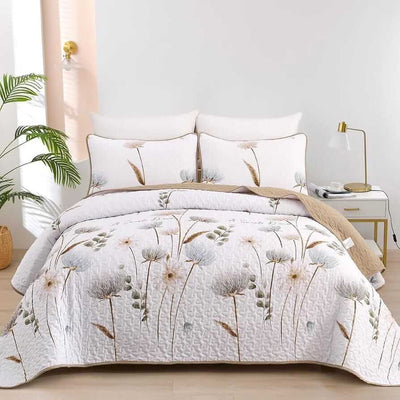 Floral-patterned comforter set on a bed with matching pillows in a bedroom setting.