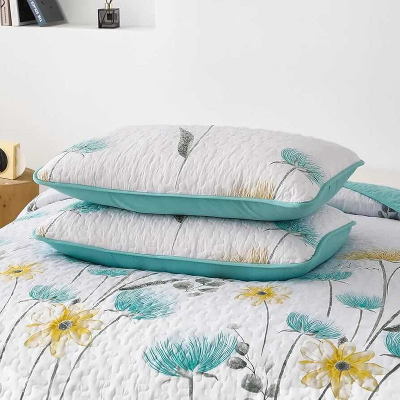 Floral patterned comforter set on a bed in a bedroom setting