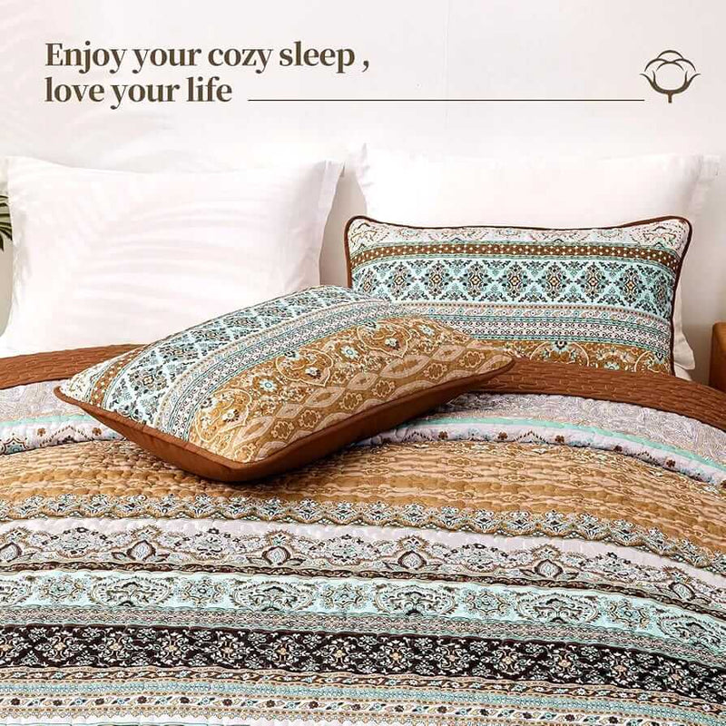 Bed with patterned quilt and pillows in a bedroom setting