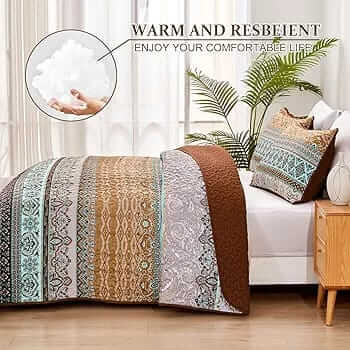 Bed with patterned quilt and pillows in a bedroom setting