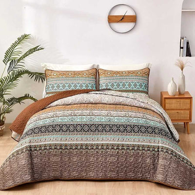 Bed with patterned quilt and pillows in a bedroom setting