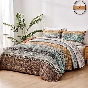 Bed with patterned quilt and pillows in a bedroom setting