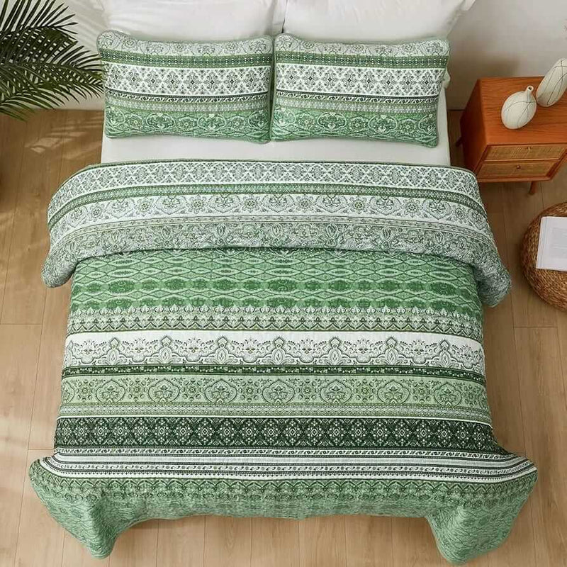 Bed with patterned quilt and pillows in a bedroom setting