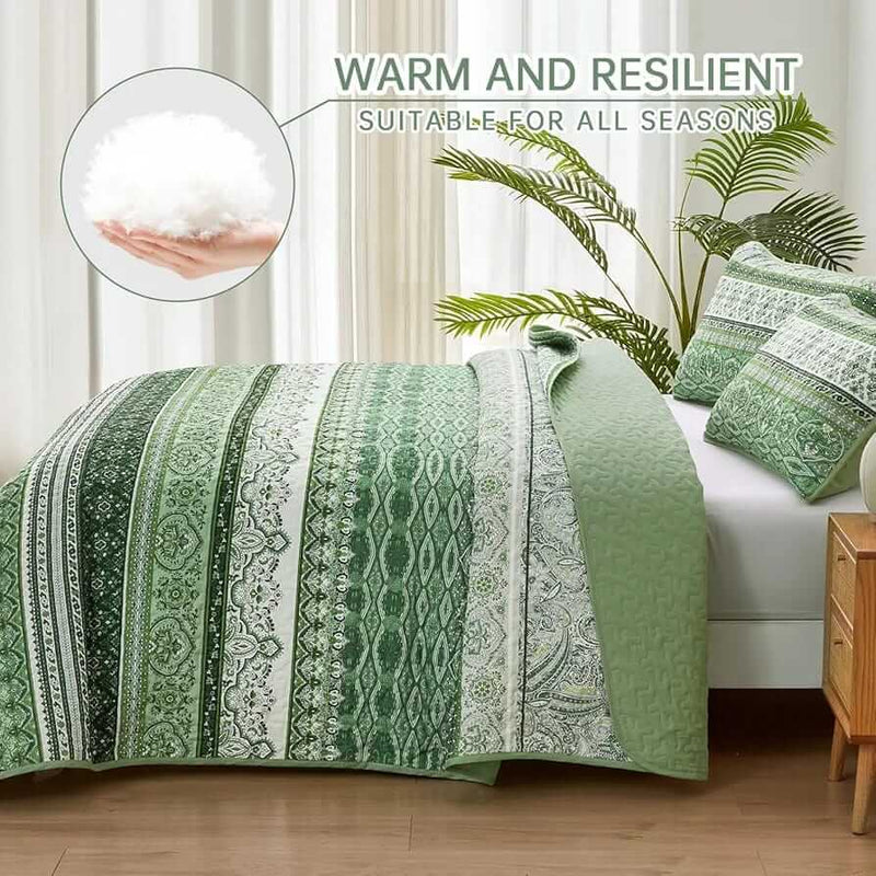 Bed with patterned quilt and pillows in a bedroom setting
