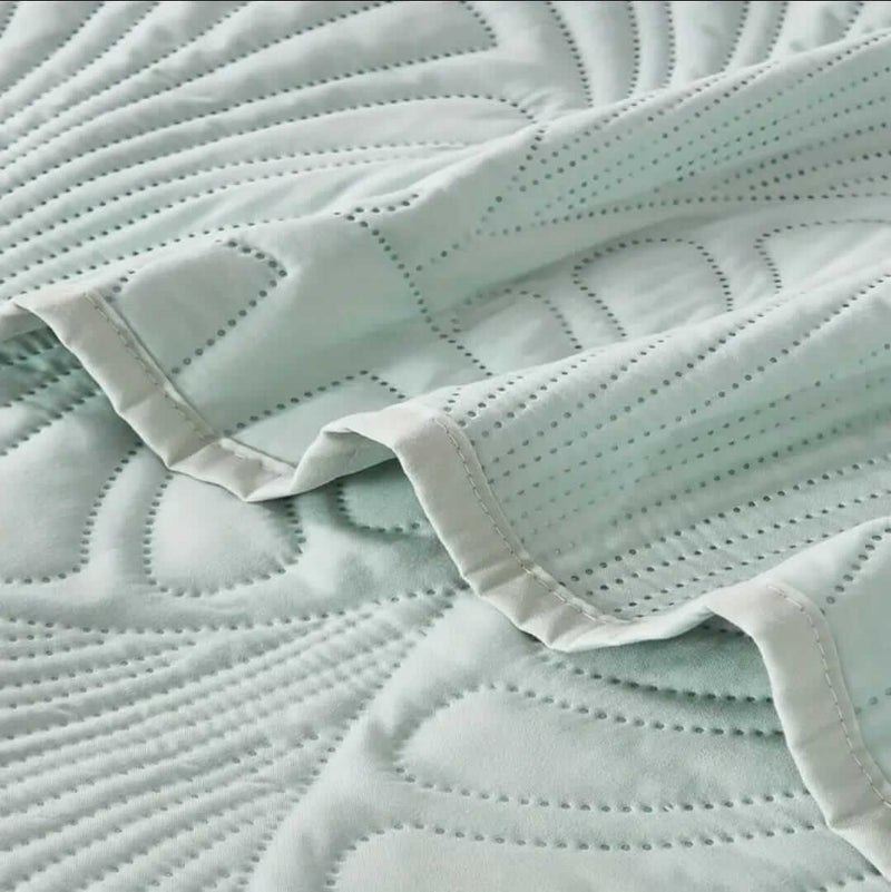 Close-up of a quilted fabric surface with a soft texture.