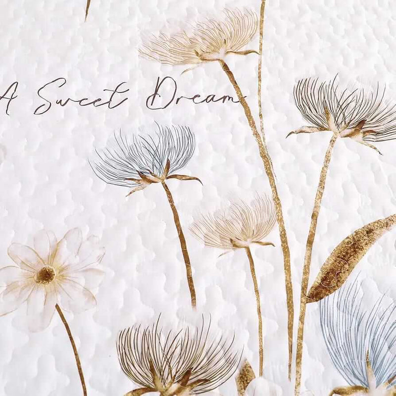 Floral-patterned comforter set on a bed with matching pillows in a bedroom setting.