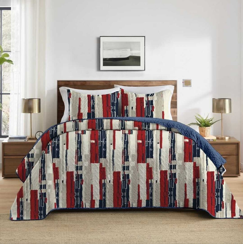 Bed with a colorful geometric patterned comforter in a bedroom setting.