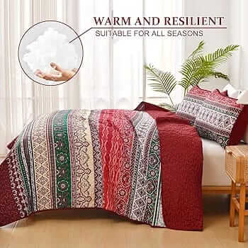 Bed with patterned quilt and pillows in a bedroom setting