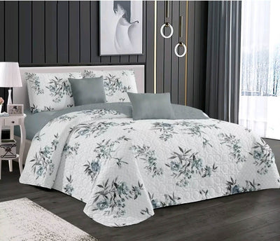 Floral patterned comforter set on a bed in a bedroom setting.