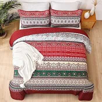 Bed with patterned quilt and pillows in a bedroom setting