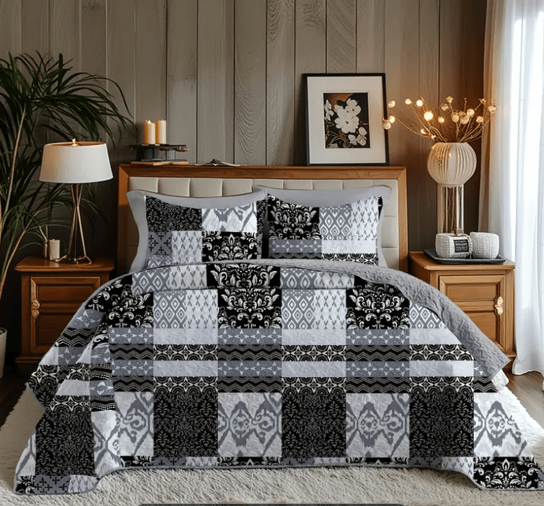 Bedroom with a bed covered in a black and white patterned comforter