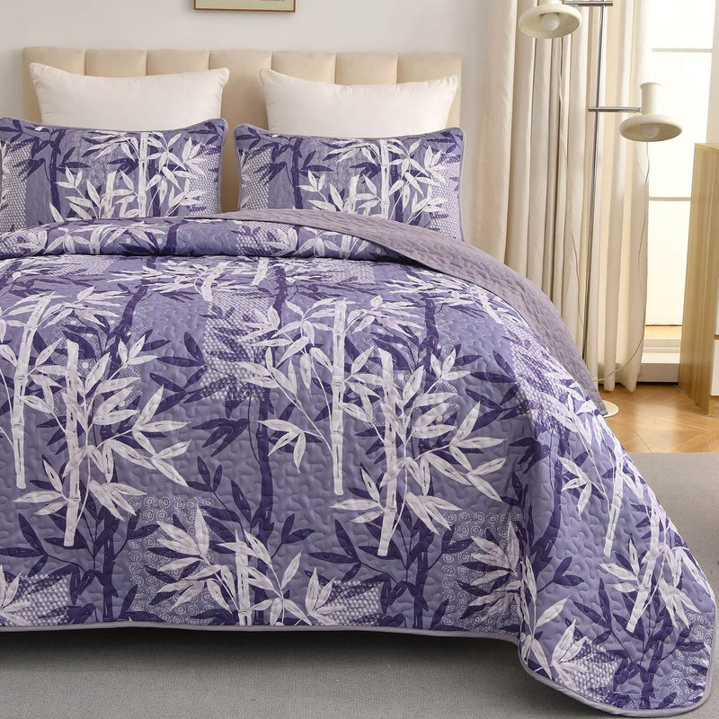Bed with a colorful quilt and pillows in a bedroom setting.