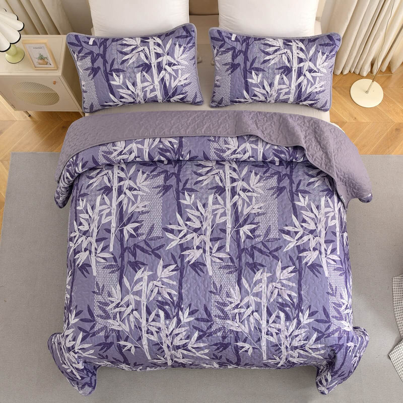 Bed with a colorful quilt and pillows in a bedroom setting.