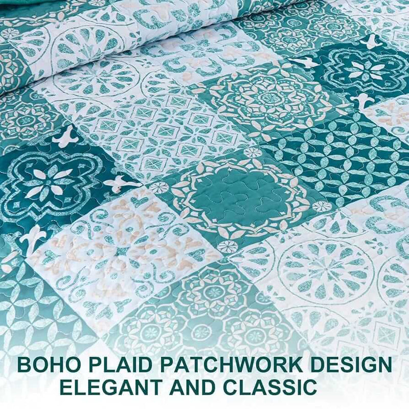 A colorful floral patterned cotton bedspread set on a bed, with a variety of matching and contrasting pillows, in a room with wooden furniture and a lamp.