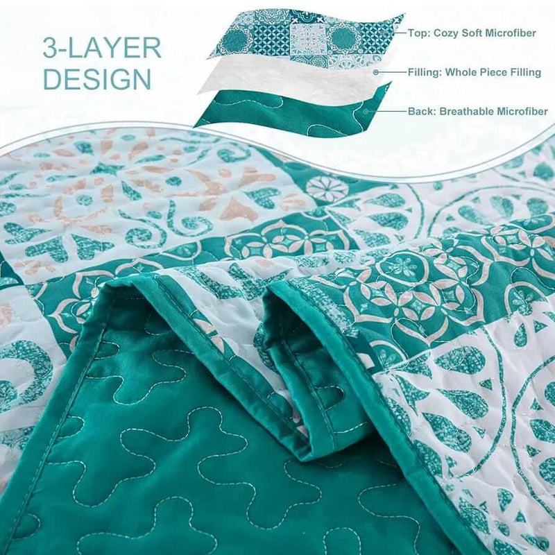 A colorful floral patterned cotton bedspread set on a bed, with a variety of matching and contrasting pillows, in a room with wooden furniture and a lamp.