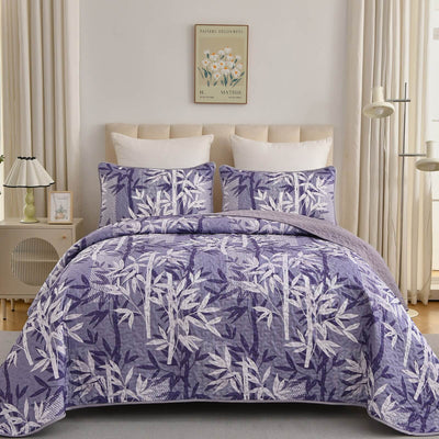 Bed with a colorful quilt and pillows in a bedroom setting.