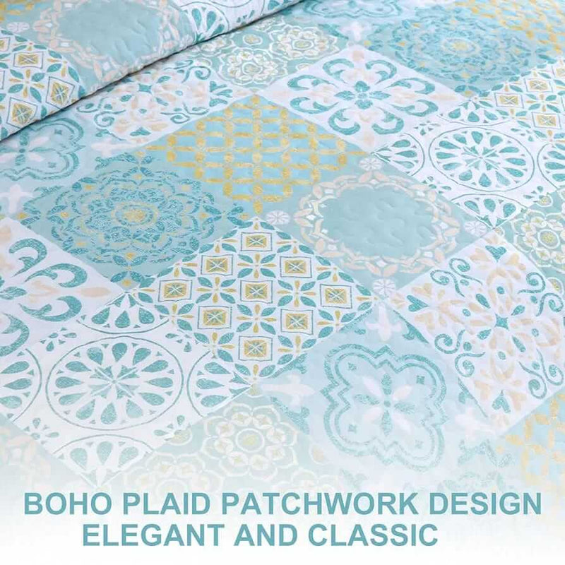 Blue and green patchwork quilt set on a bed in a bedroom.
