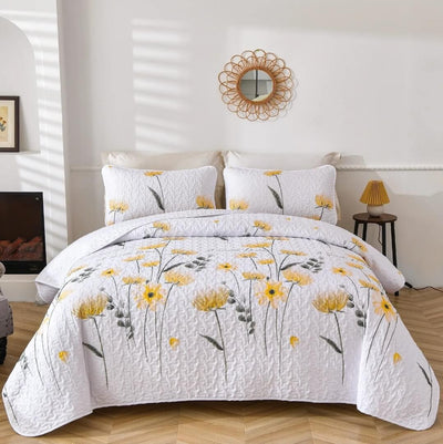 Floral patterned comforter set on a bed in a bedroom with a mirror and lamp.
