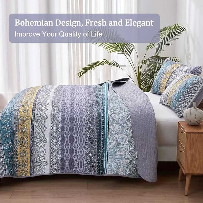 Bed with a colorful quilt and pillows in a bedroom setting.