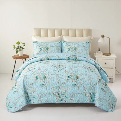 Floral patterned comforter set on a bed in a bedroom setting.