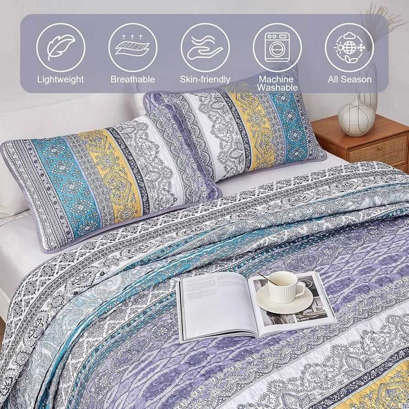 Bed with a colorful quilt and pillows in a bedroom setting.