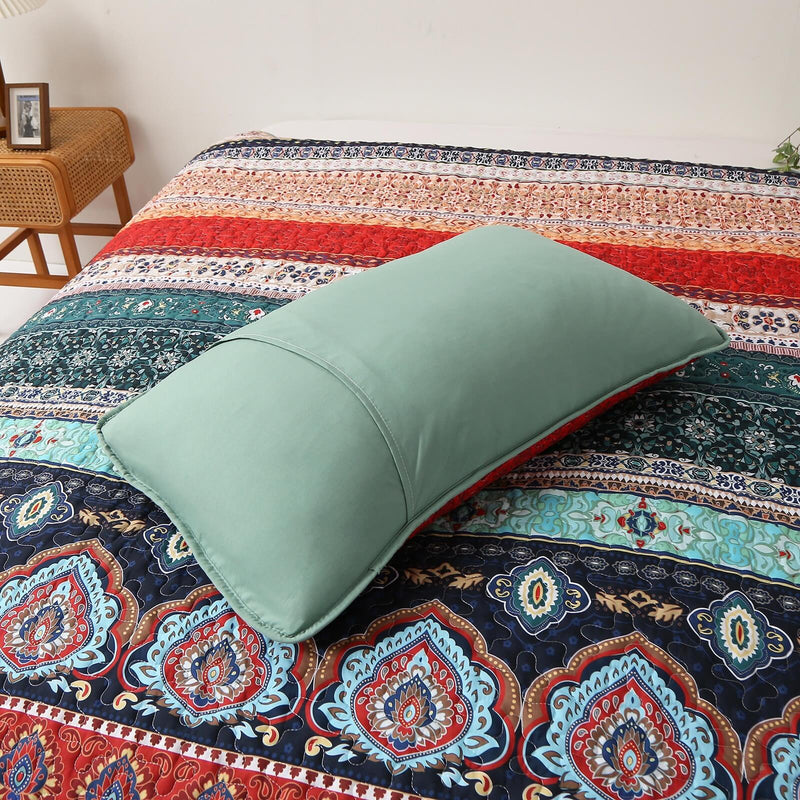 Floral patterned comforter set on a bed in a bedroom setting