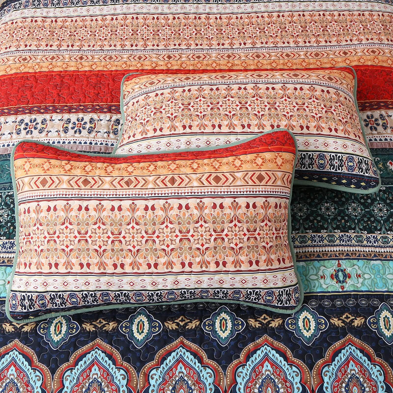 Floral patterned comforter set on a bed in a bedroom setting