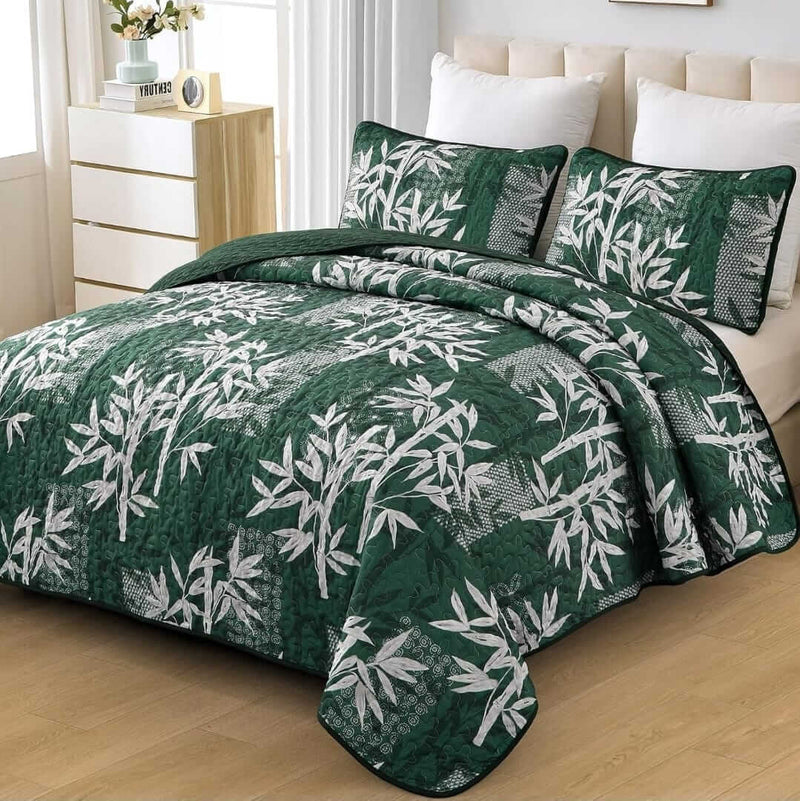 Bed with a colorful quilt and pillows in a bedroom setting.