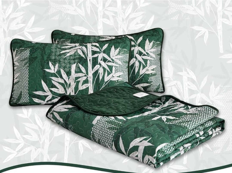 Bed with a colorful quilt and pillows in a bedroom setting.