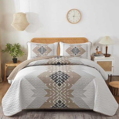 Bed with patterned quilt and pillows in a bedroom setting