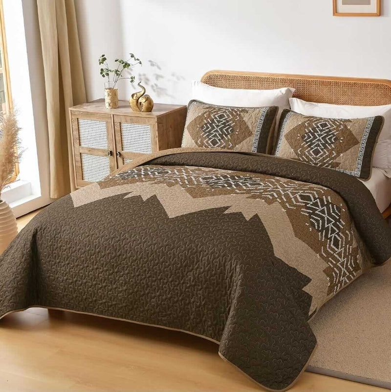 Patchwork quilt set on a bed in a bedroom with a wooden headboard.