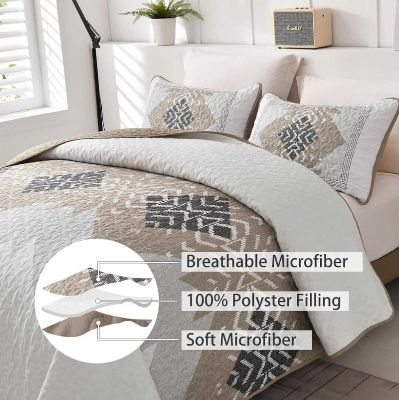 Bed with patterned quilt and pillows in a bedroom setting