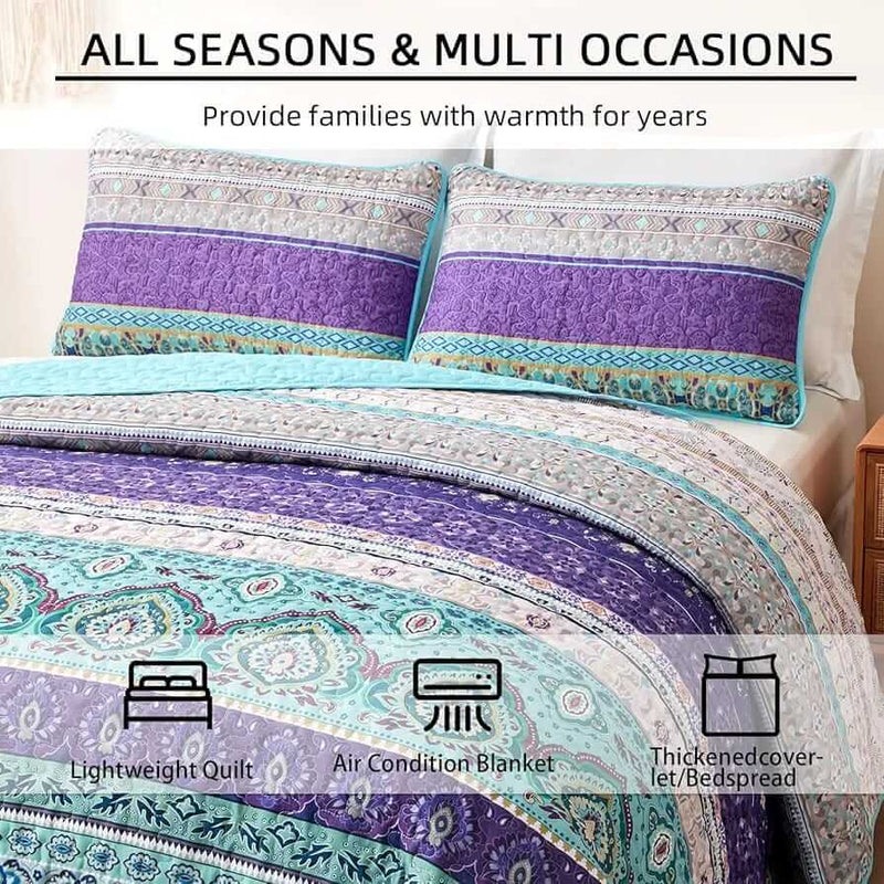 Bed with a colorful quilt and pillows in a bedroom setting.