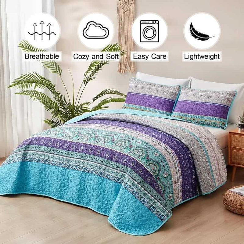 Bed with a colorful quilt and pillows in a bedroom setting.