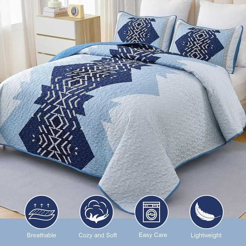 Patchwork quilt set on a bed in a bedroom with a wooden headboard.