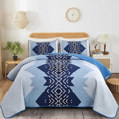 Patchwork quilt set on a bed in a bedroom with a wooden headboard.