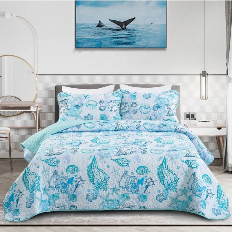 Bed with blue sea-themed bedding set, whale painting on wall.
