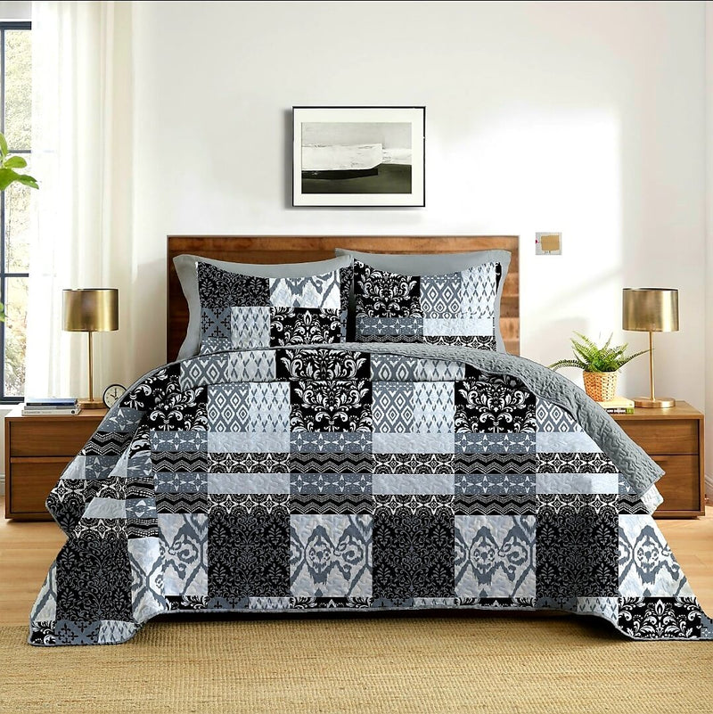 Bedroom with a bed featuring a black and gray patterned comforter.