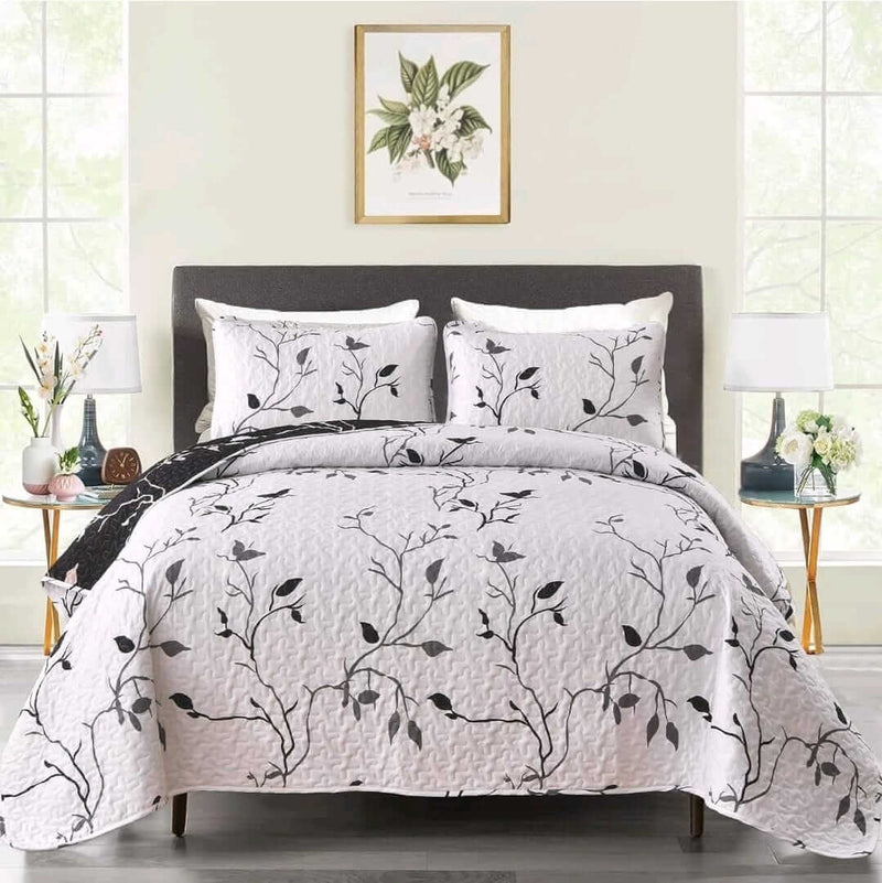 Bed with floral-patterned bedding in a bright bedroom setting