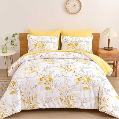 Floral bedding set with yellow and white design on a bed in a bedroom.