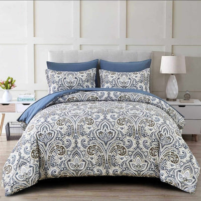 Bed with paisley patterned comforter and pillows in a bedroom setting.