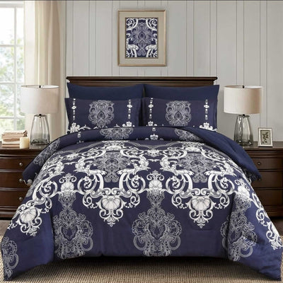 Navy blue and white patterned comforter set on a bed in a bedroom setting.