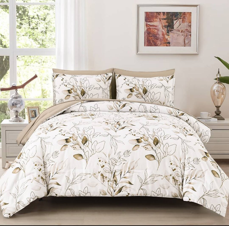 Floral patterned comforter set on a bed in a bedroom with a window and decor.