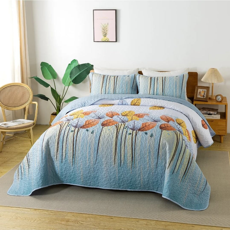 Floral quilt on a bed in a bedroom with a chair and plant.