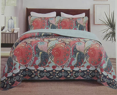 Decorative throw blanket with paisley pattern draped over a wooden surface.