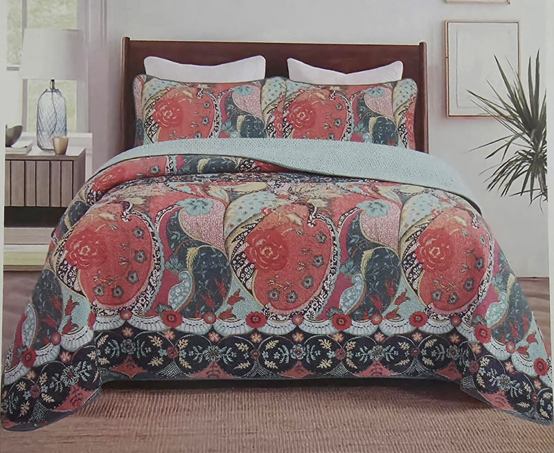 Decorative throw blanket with paisley pattern draped over a wooden surface.