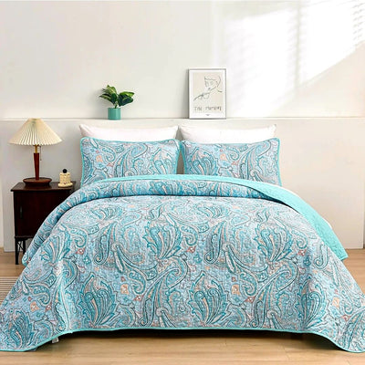 Teal paisley patterned comforter set on a bed in a bedroom setting.
