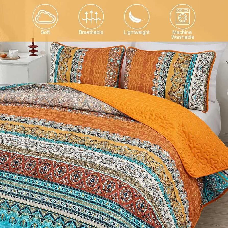 Bed with patterned quilt and pillows in a bedroom setting