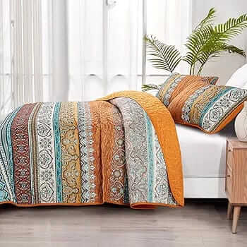 Bed with patterned quilt and pillows in a bedroom setting