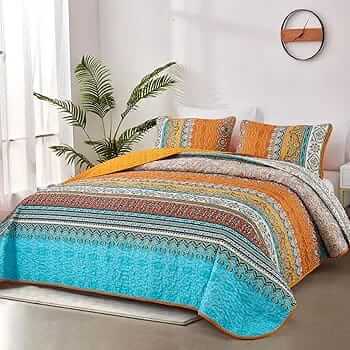 Bed with patterned quilt and pillows in a bedroom setting